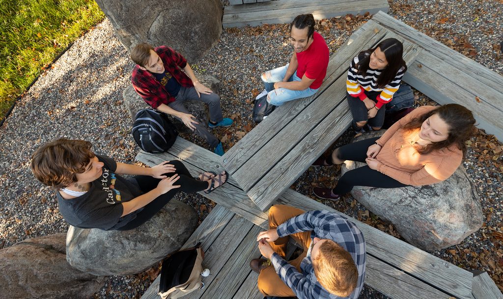 Overhead view of six students sitting outside