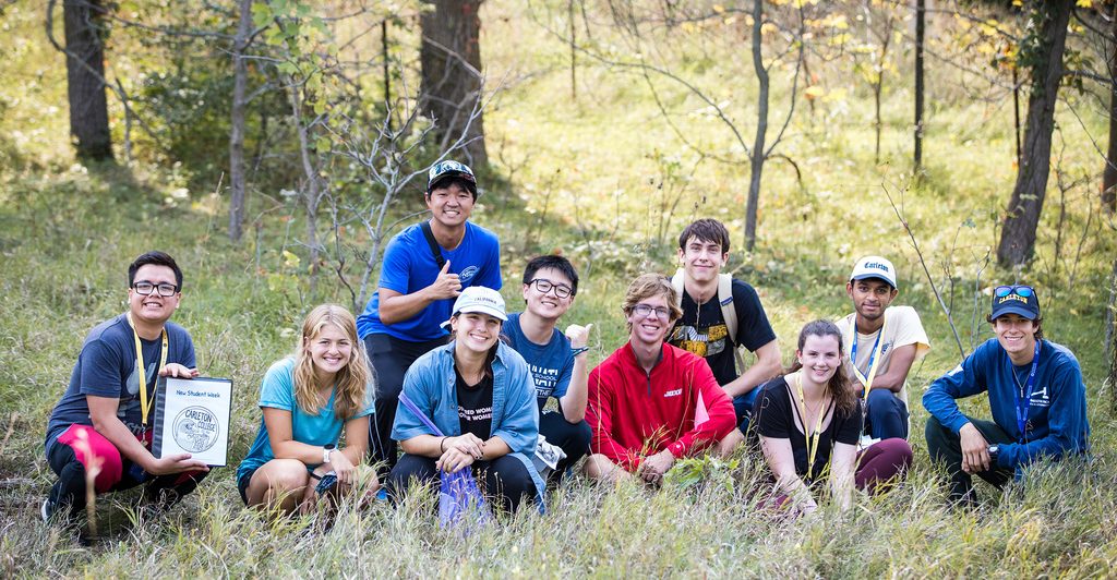 A group of students poses for a photo after planting trees in the arboretum