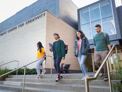 Four students walking out of the Weitz Center for Creativity.