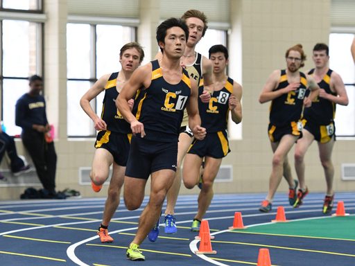 A cluster of Carleton runners round the track during the indoor season.