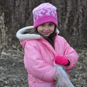 Aya Myint, 5, lends a hand and a smile in the last prairie planting before winter.