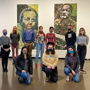 A group of students in an art gallery, wearing COVID masks