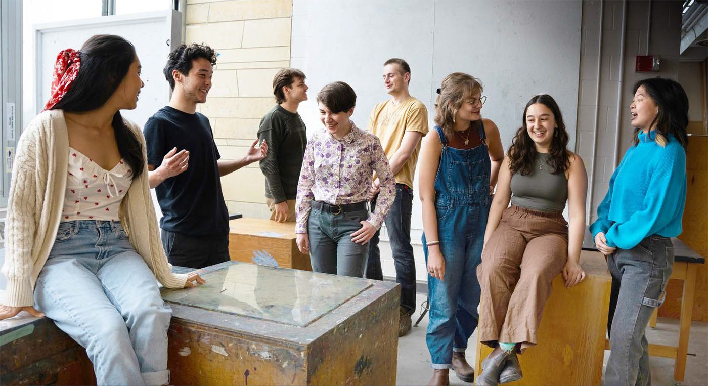 Eight students in an art studio