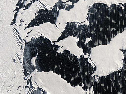 Peeling and dripping white paint on a black surface