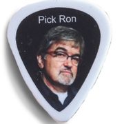 A guitar pick with professor Ron Rodman's face and the words 