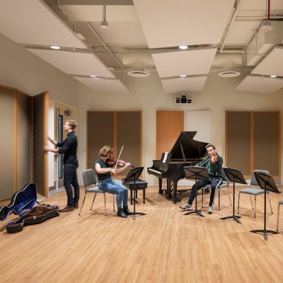 Student violinists and cellist rehearse in Puzak Chamber Studio in the Weitz Center for Creativity.