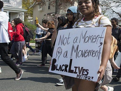 black lives matter protester with sign