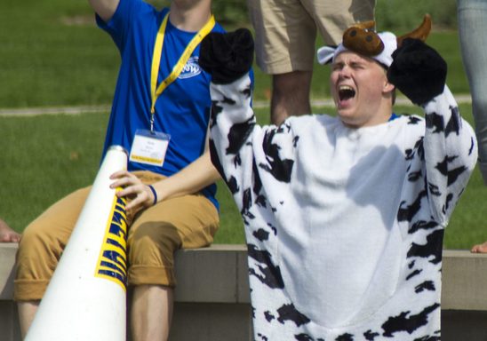 A student dressed as a cow welcoming new students during NSW