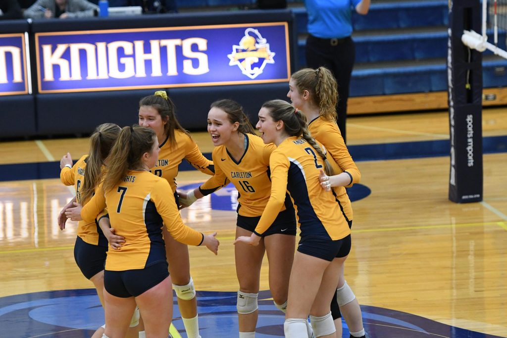 The womens volleyball team celebrates after a win