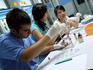 Three students at a table doing some sort of work