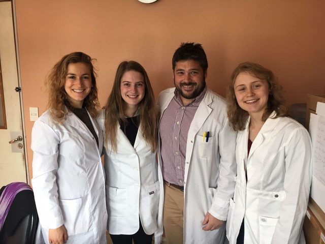 Anna Karmel and three other people in lab coats
