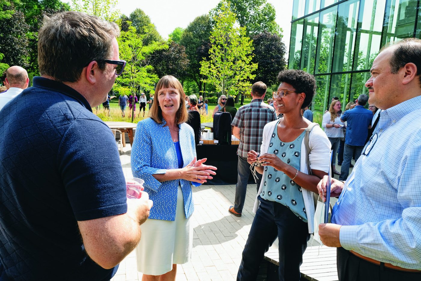 President Byerly chats with Carleton staff members outside the Weitz Center
