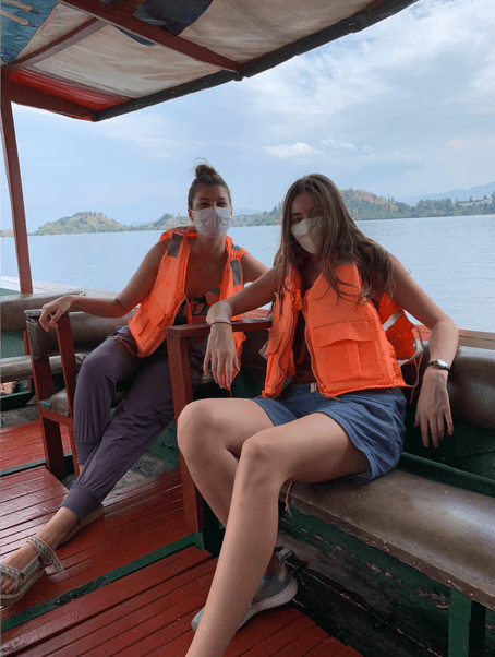 Two female students in lifejackets on a boat