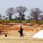 pile of salt desert with woman walking past in Senegal