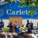 graduate receiving their diploma on stage from President Byerly