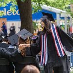 Graduate celebrating with other graduates