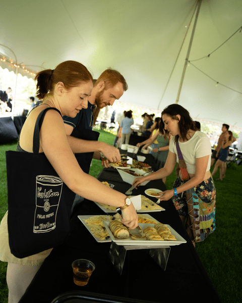 Members of the Class of 2022 enjoy appetizers under the tent