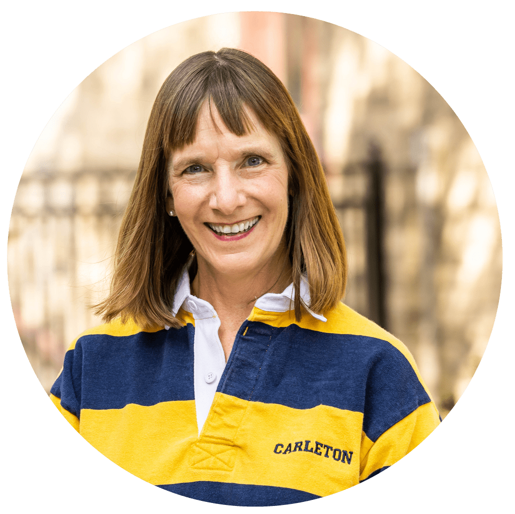 President Alison Byerly headshot dressed in Carleton colored rugby shirt