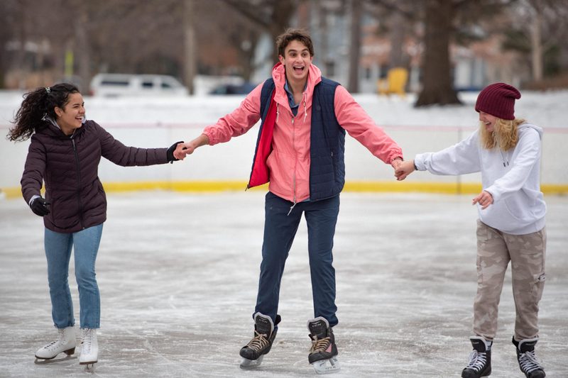 Three students ice skating on the Bald Spot