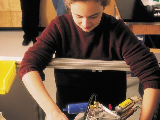 A student prepares a piece of equipment for a science experiment
