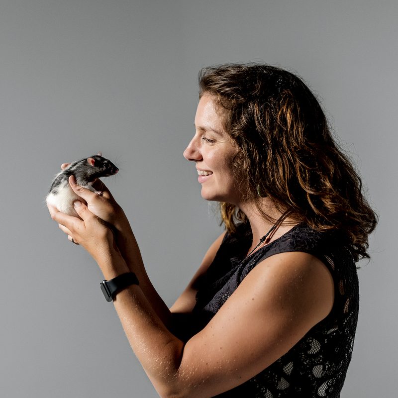 professor Sarah Meerts holds a black & white lab rat