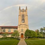 A rainbow arching over a tall chapel building.
