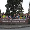 Trip members gathered at sign for Hawaiian Volcano Observatory