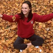 melissa sitting in a pile of leaves