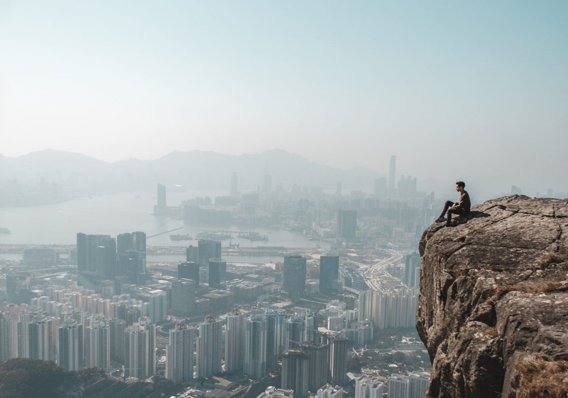 Person on Cliff Overlooking Hong Kong