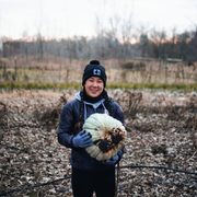 Student holding pumpkin