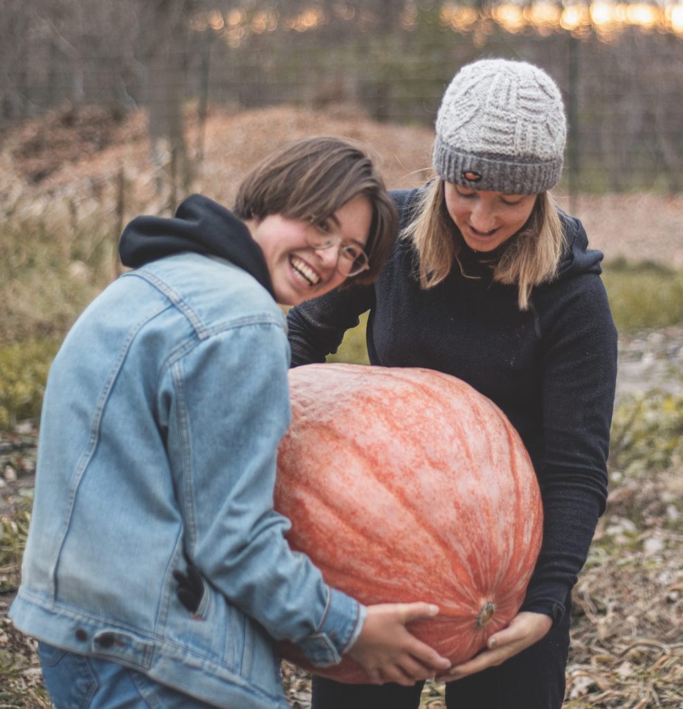 Students holding pumpkin