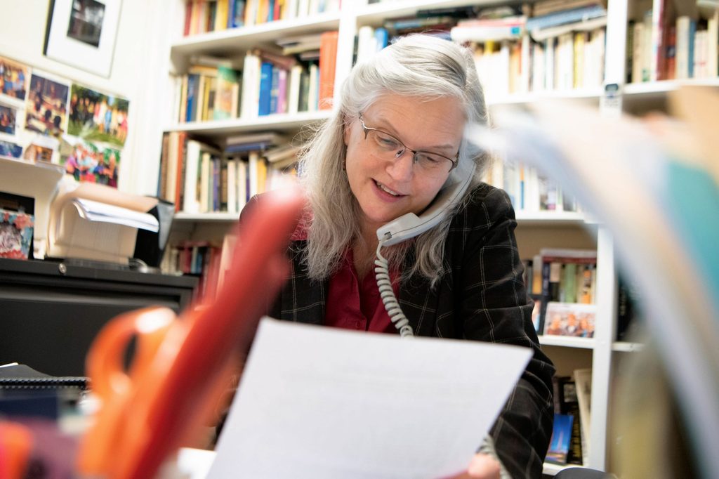 Carolyn Fure-Slocum talking on an office telephone