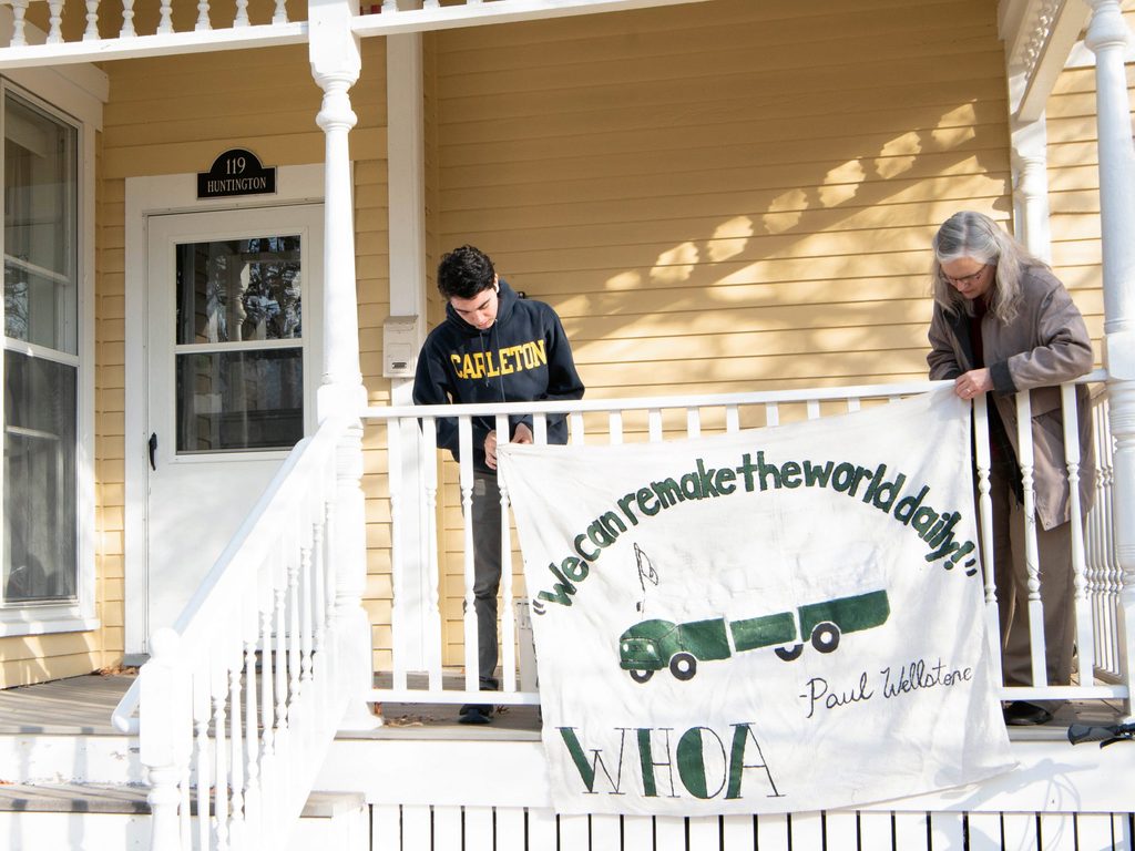 Hanging a porch banner at WHOA House