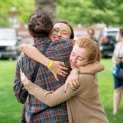 Class of 2020 friends greet each other with a hug