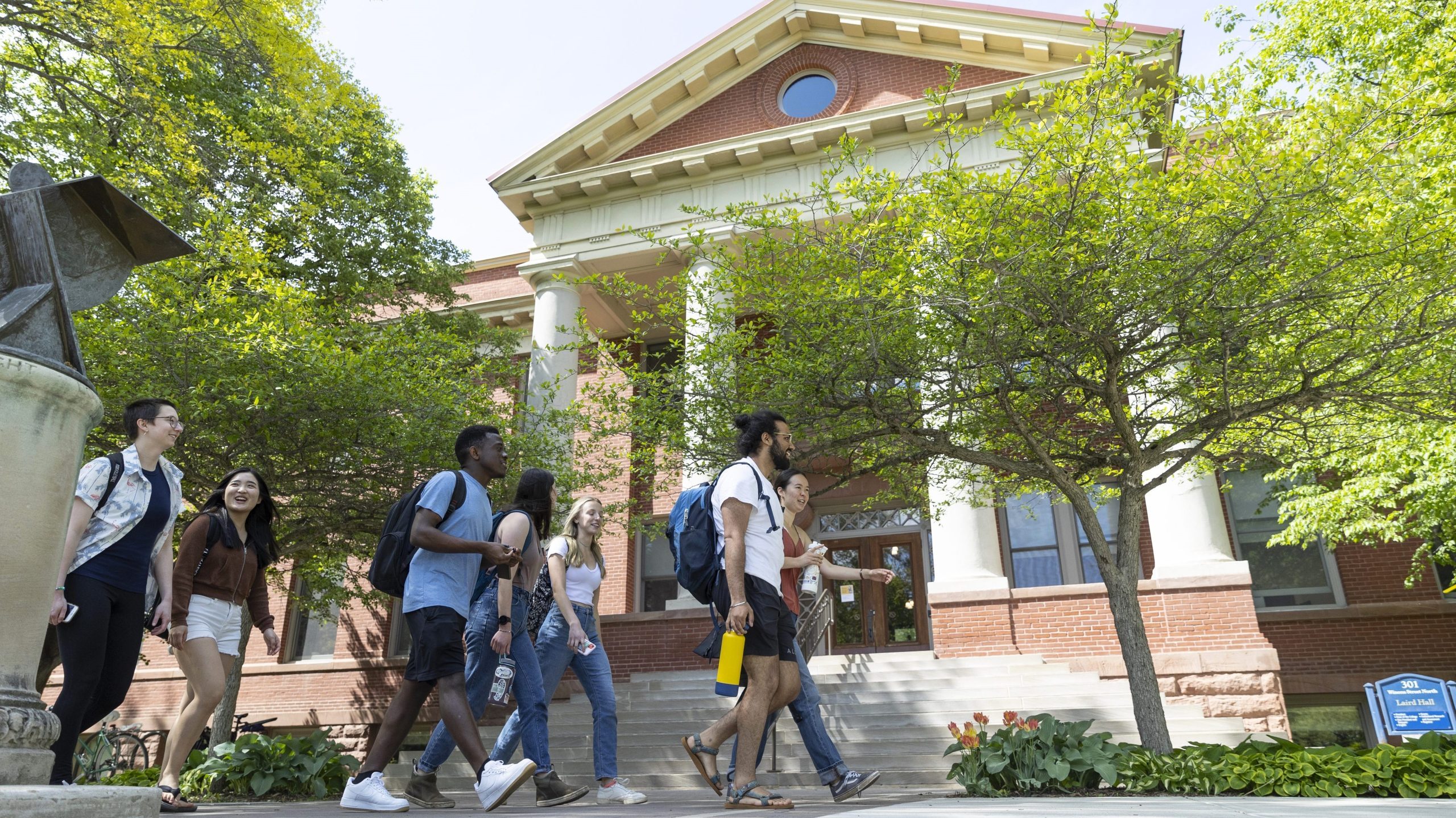 students walking in front of building