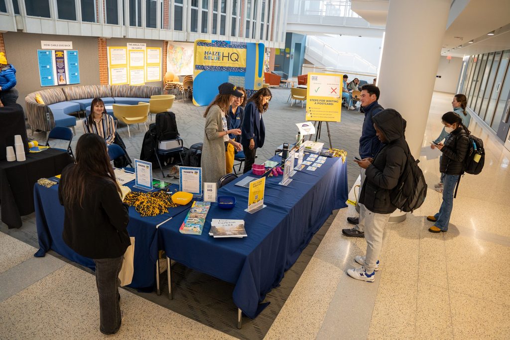 Student checks out info at display table