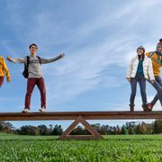 Four students balance on a gigantic see-saw