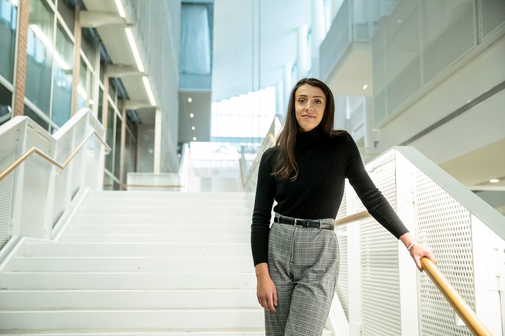 A student stands on a stairway