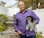 a man holding a dog