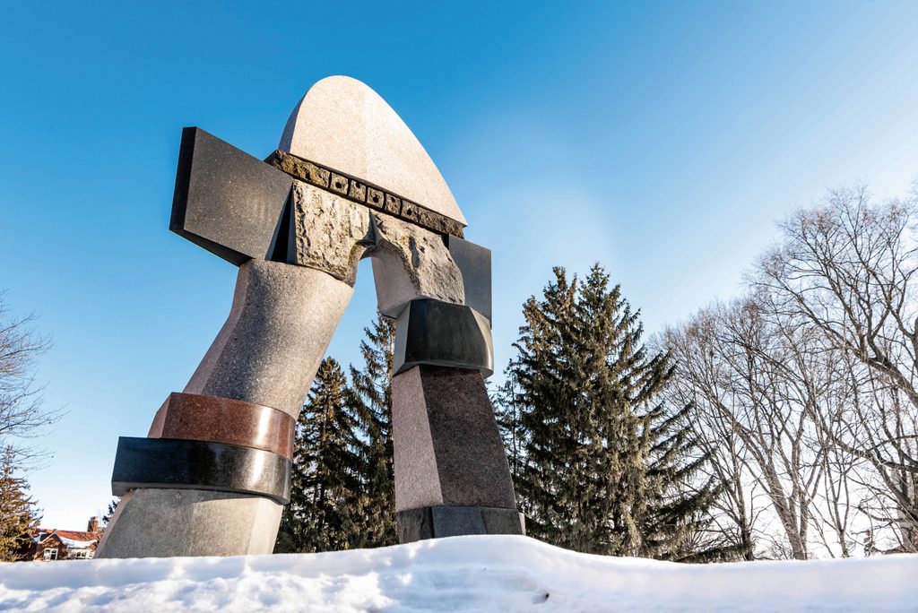 A sculpture with snow and trees and blue sky