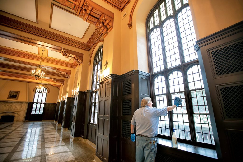 a custodian cleans a window